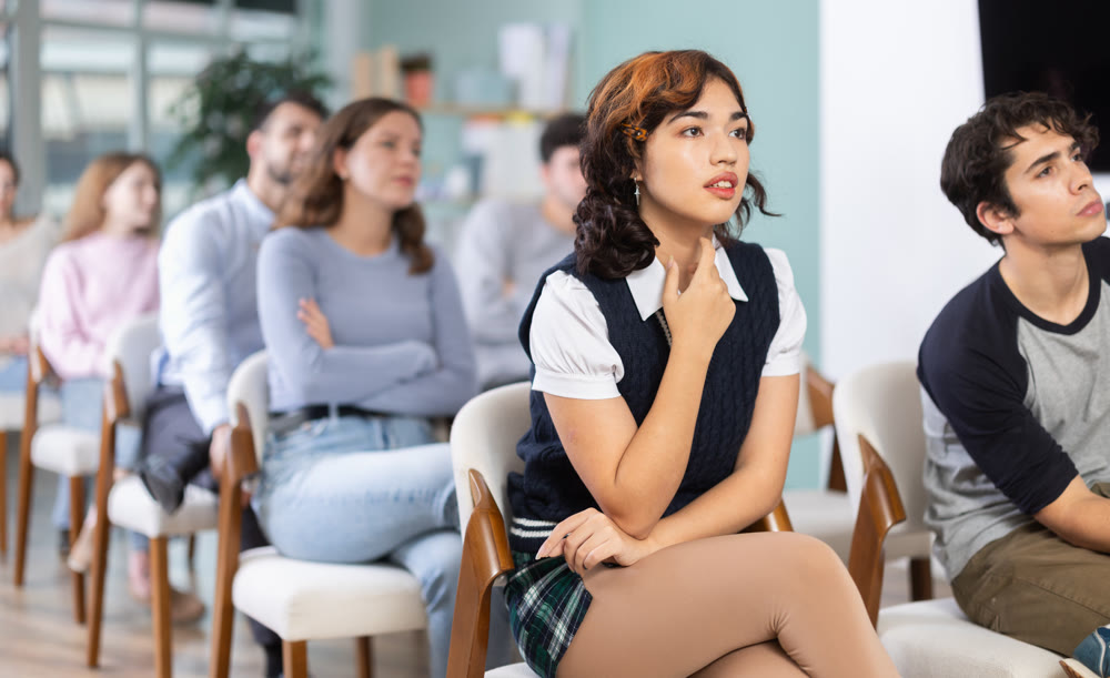 Students sit attentively in the classroom and listen to lectures