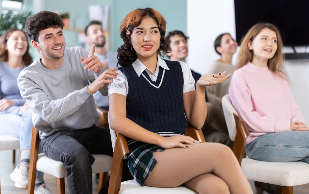 Classmates listening and talking during group discussion in class