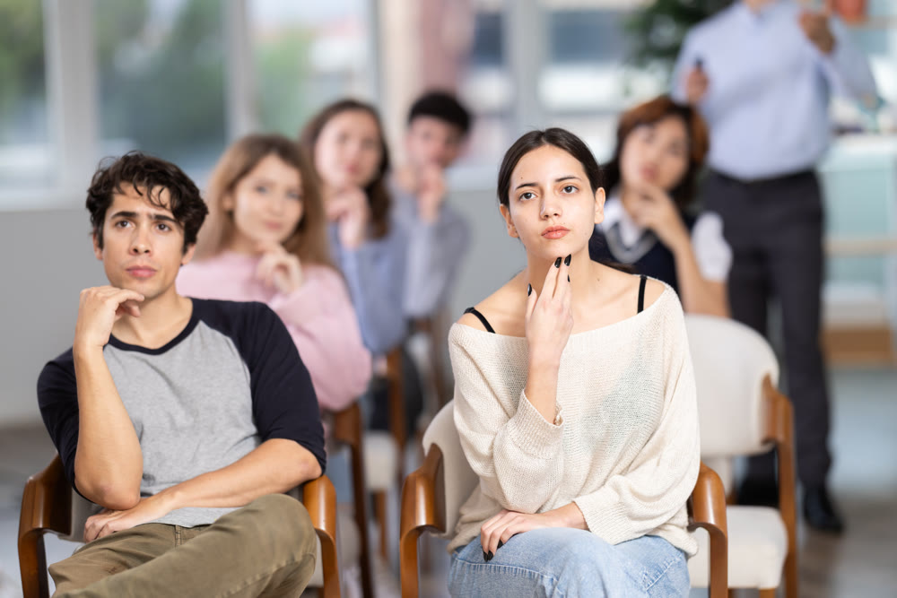 Young people are listening to lecture in auditorium