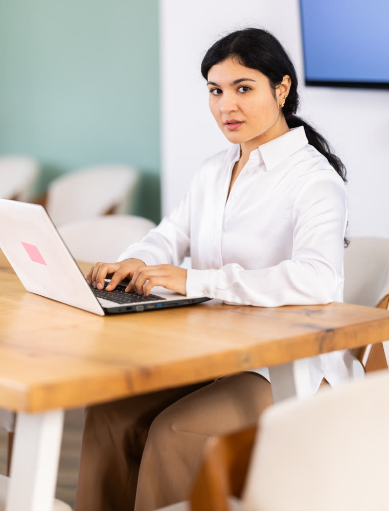 Female works on laptop in room