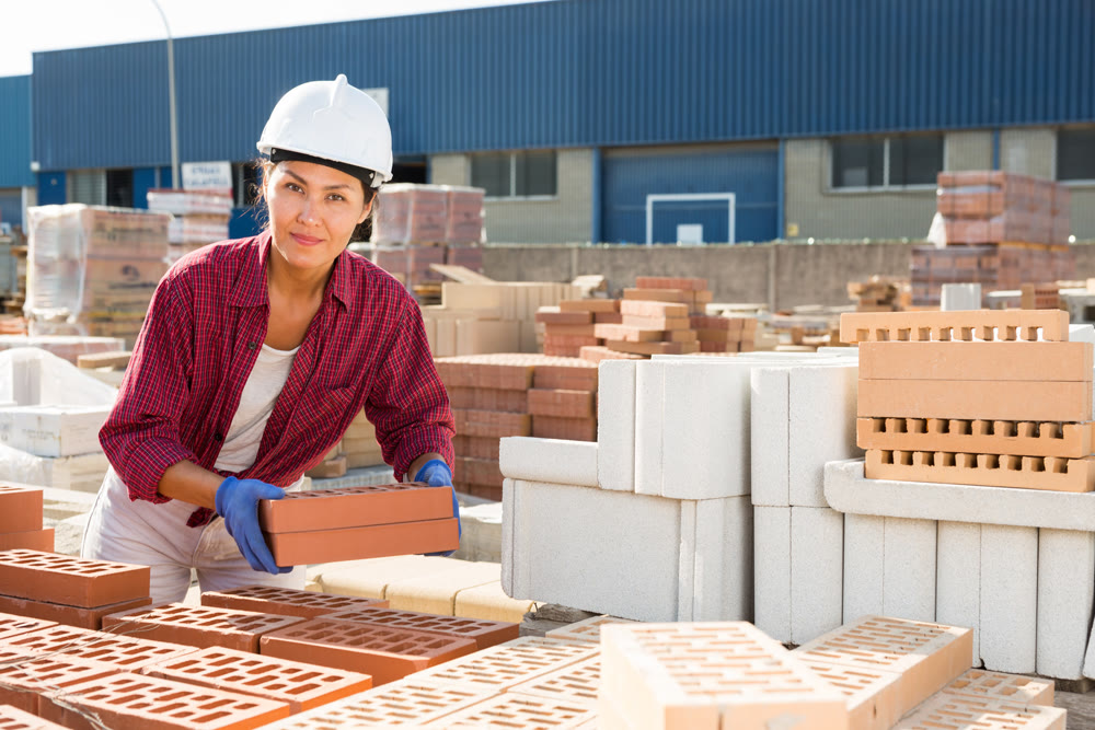 Female builder working in outdoor storage