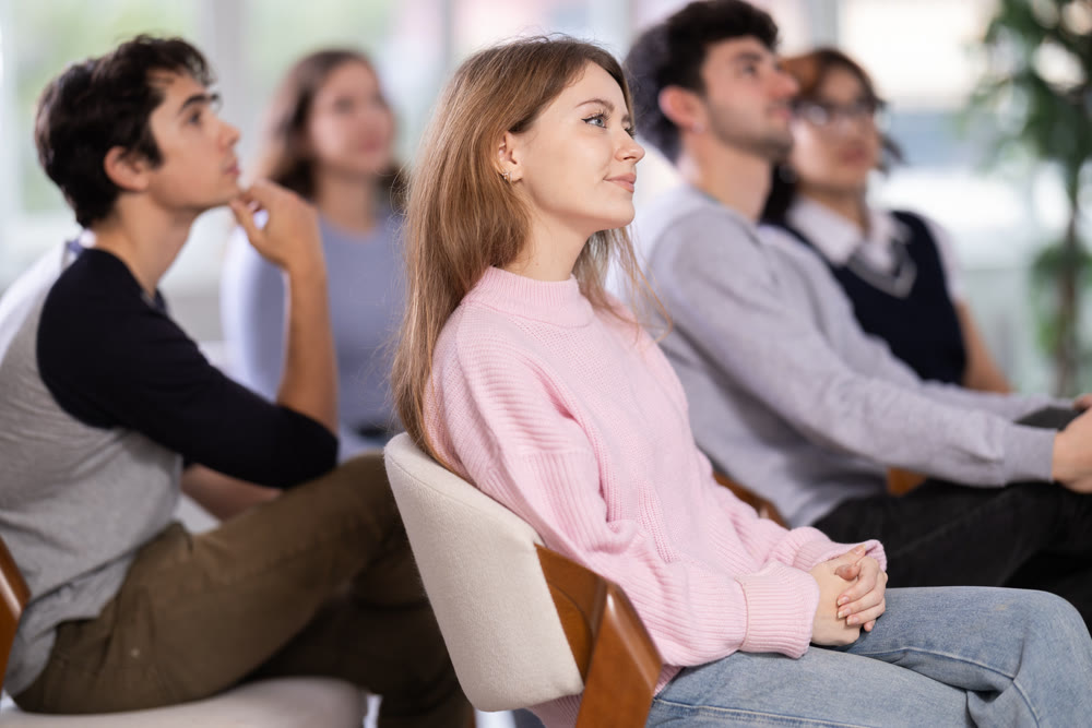 Young people are listening to lecture in auditorium