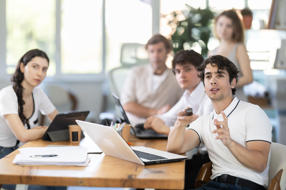 Male and female colleagues watching presentation in office