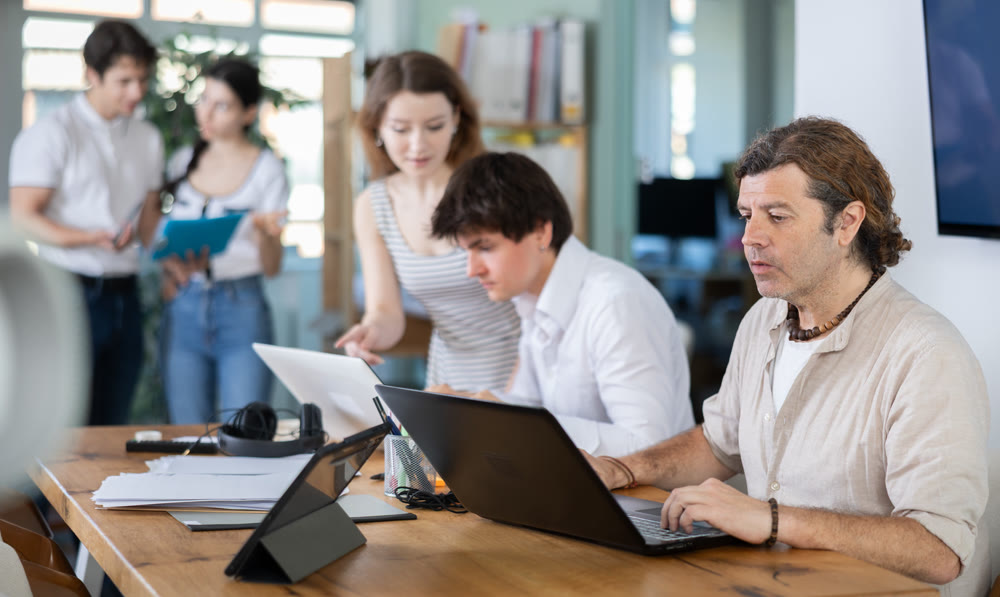 Adult man working on laptop in modern office