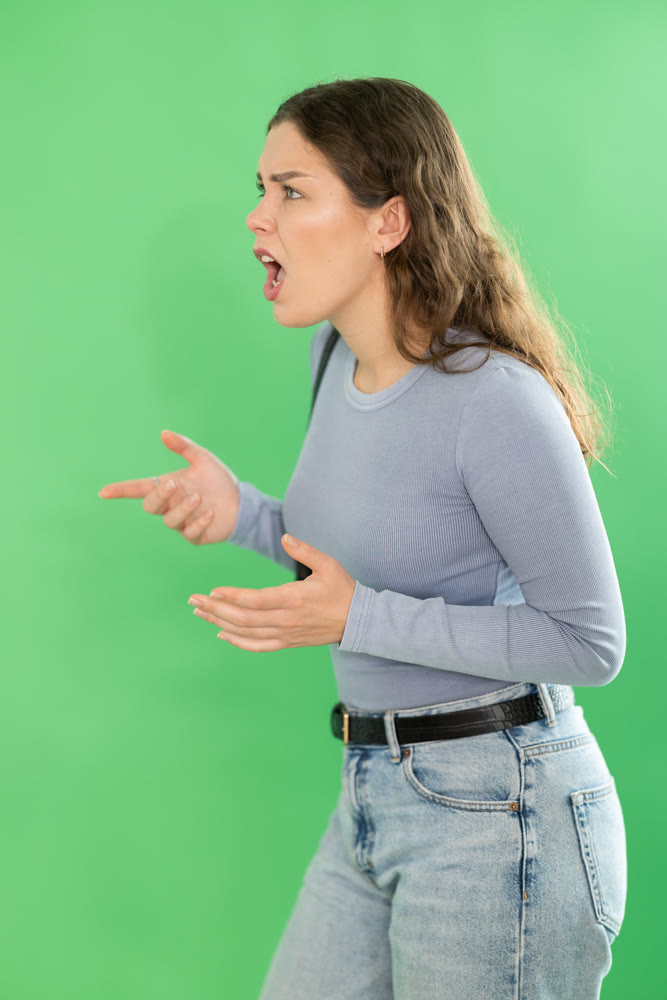 Aggressive woman expresses negative emotions by screaming and waving her arms. Chroma key compositing
