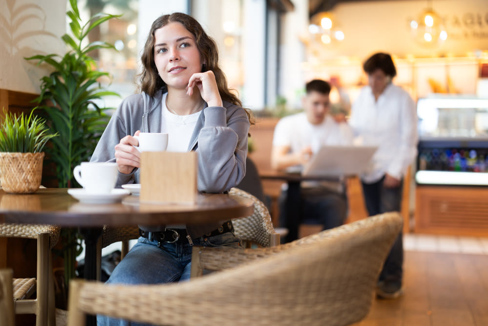 Young woman drinking coffee in cafe