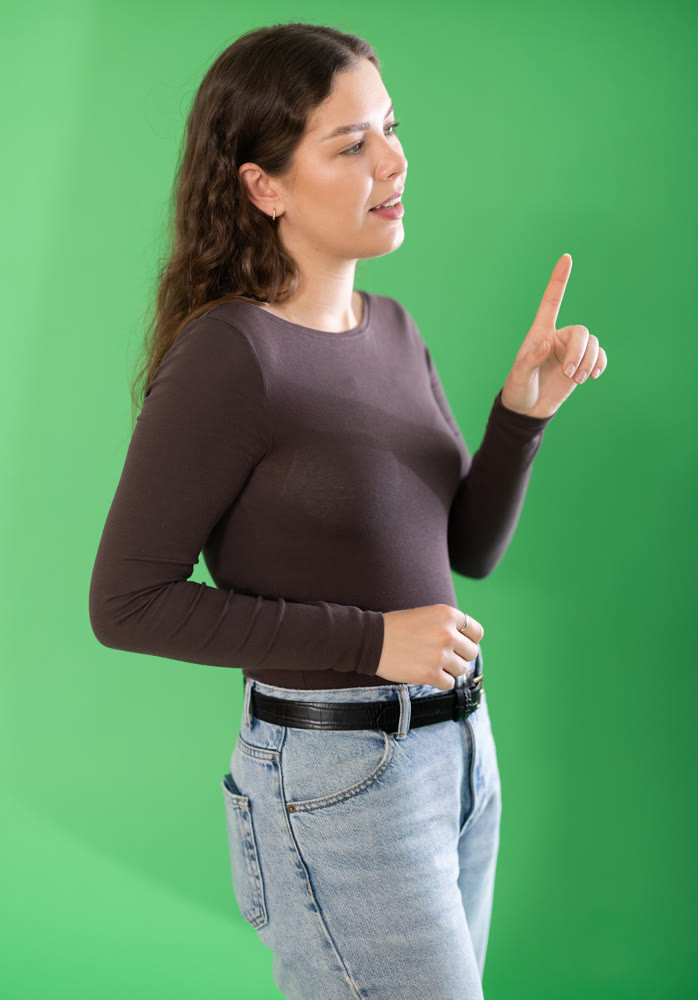 Pretty girl taps her finger on virtual screen in front of her. Chroma key compositing