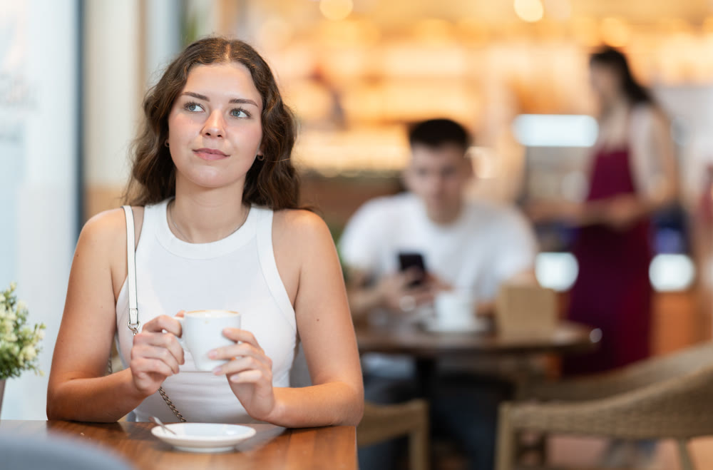 Young woman drinking coffee in cafe