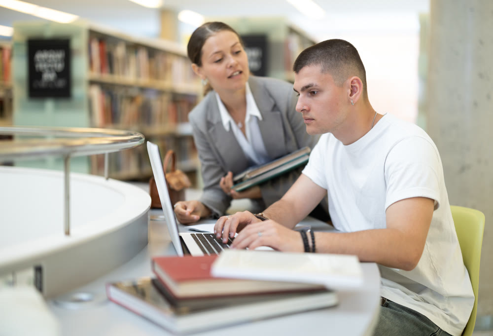female student and a guy are preparing for lectures