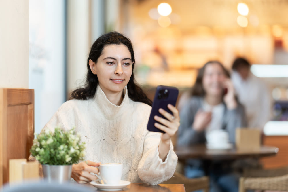 Young woman with phone in cafe