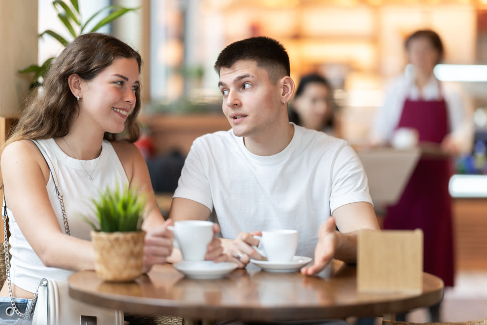 Girl in cafe sits near guy companion, has nice conversation