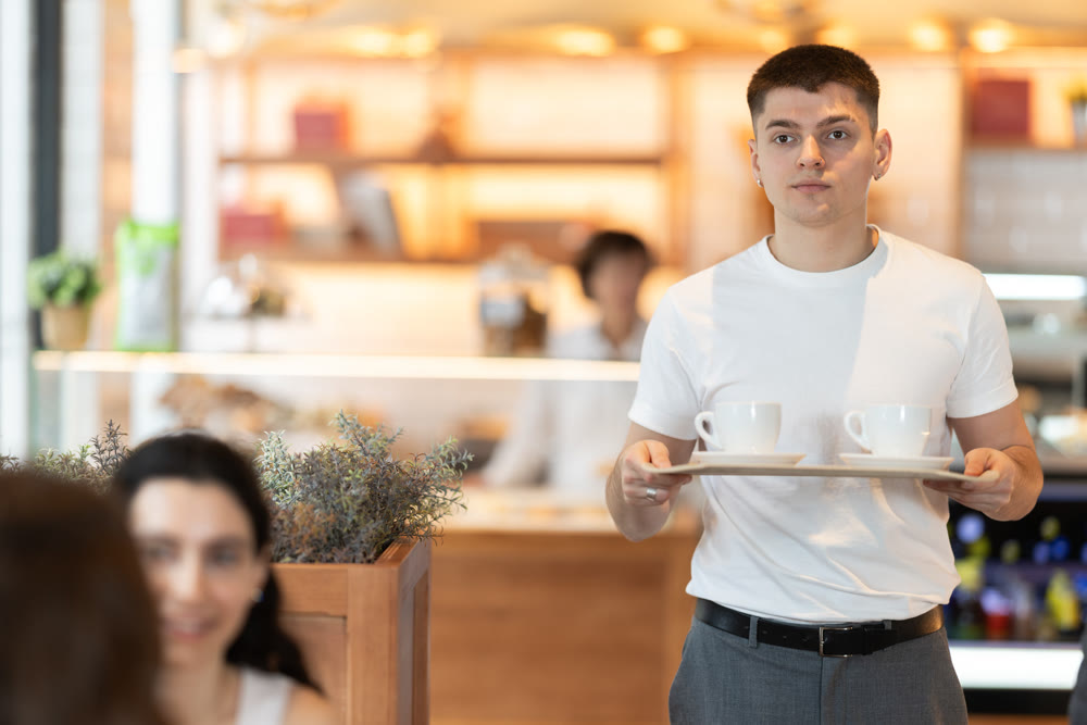 Guy carries tray with coffee