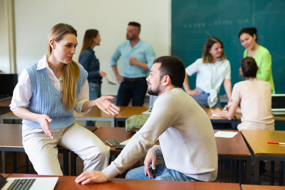 Positive student is chatting with a fellow student girl