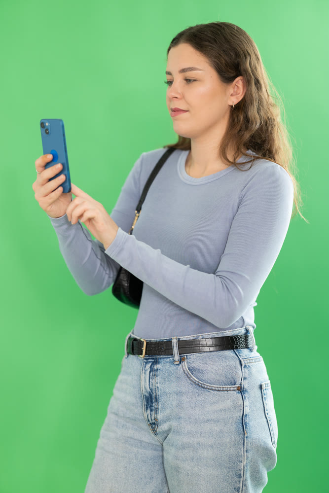 Young woman scans QR code or takes photo