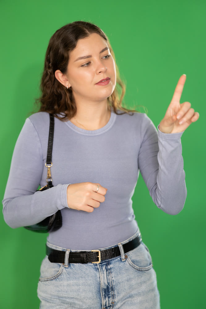 Young woman moves her finger across virtual screen