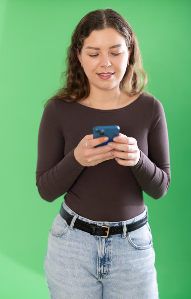 Female person girl scrolls phone screen or types text message