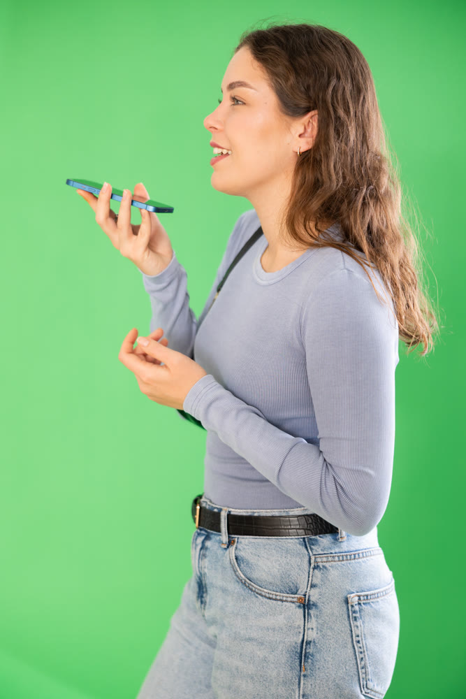 Girl records voice message using voice recorder or communicates by voice messages in messengers