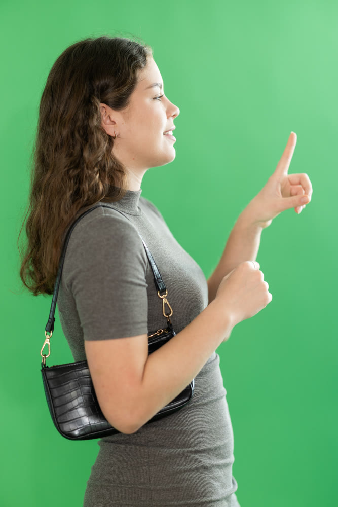 Young woman moves her finger across virtual screen