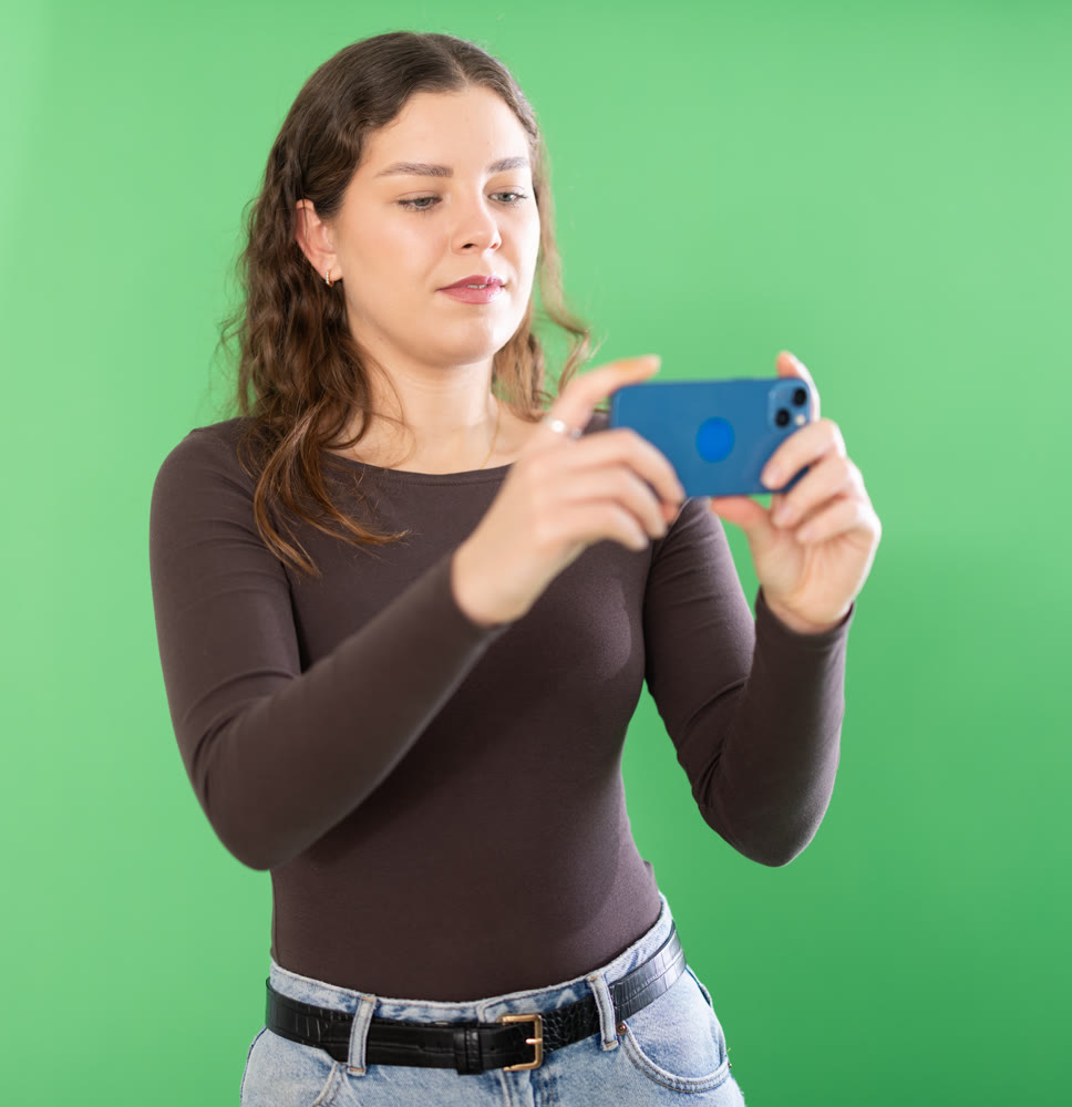 Young woman scans QR code or takes photo