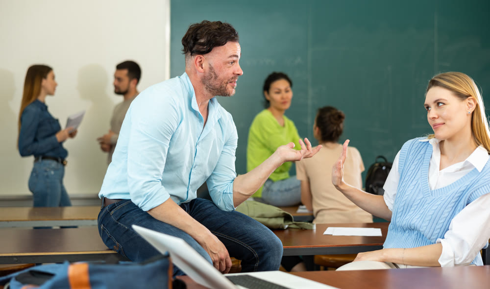 Positive student is chatting with a fellow student girl