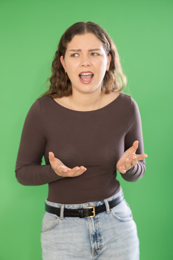 Outraged European young woman is yelling at someone