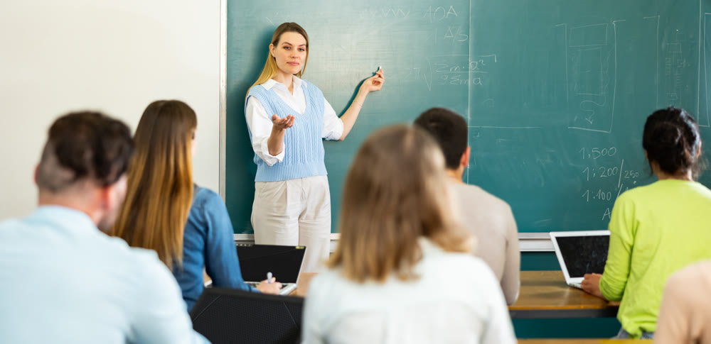 Woman teacher explaining lesson to students