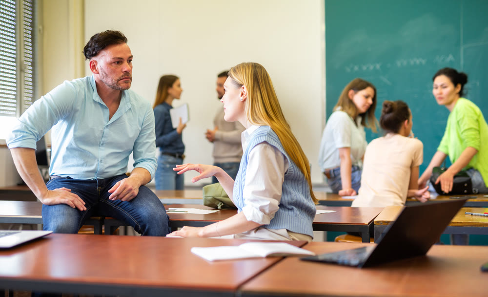 Positive student is chatting with a fellow student girl