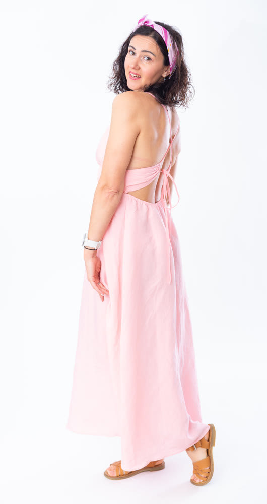 Portrait of an attractive adult woman in a pink dress on white background
