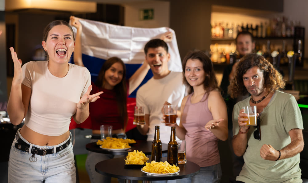 Group of fans in bar with Russian flag