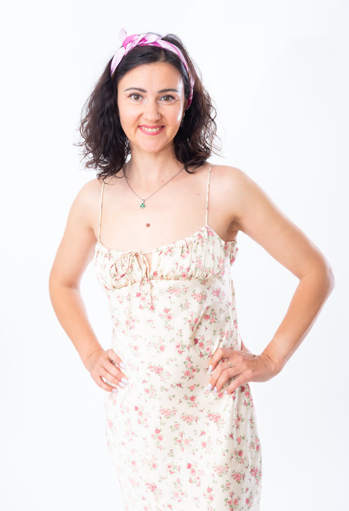 Portrait of an attractive slim woman in long summer dress on white background