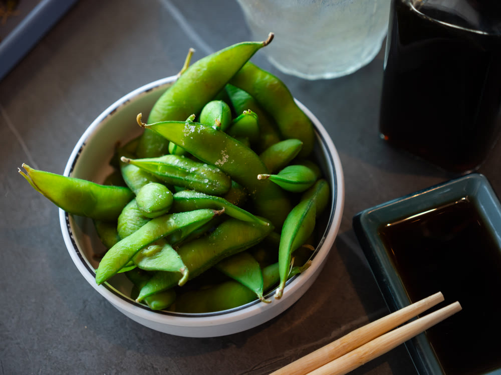Boiled edamame in a plate top view