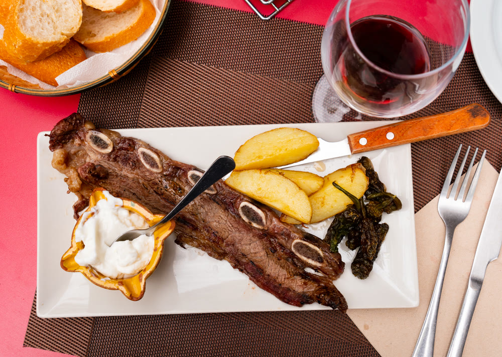 Grilled beef churrasco with roasted potatoes, peppers, and aioli