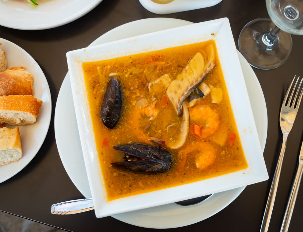 Traditional Spanish soup with seafood in a bowl view from above