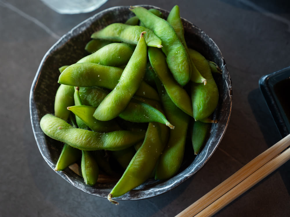 Boiled edamame in a plate top view