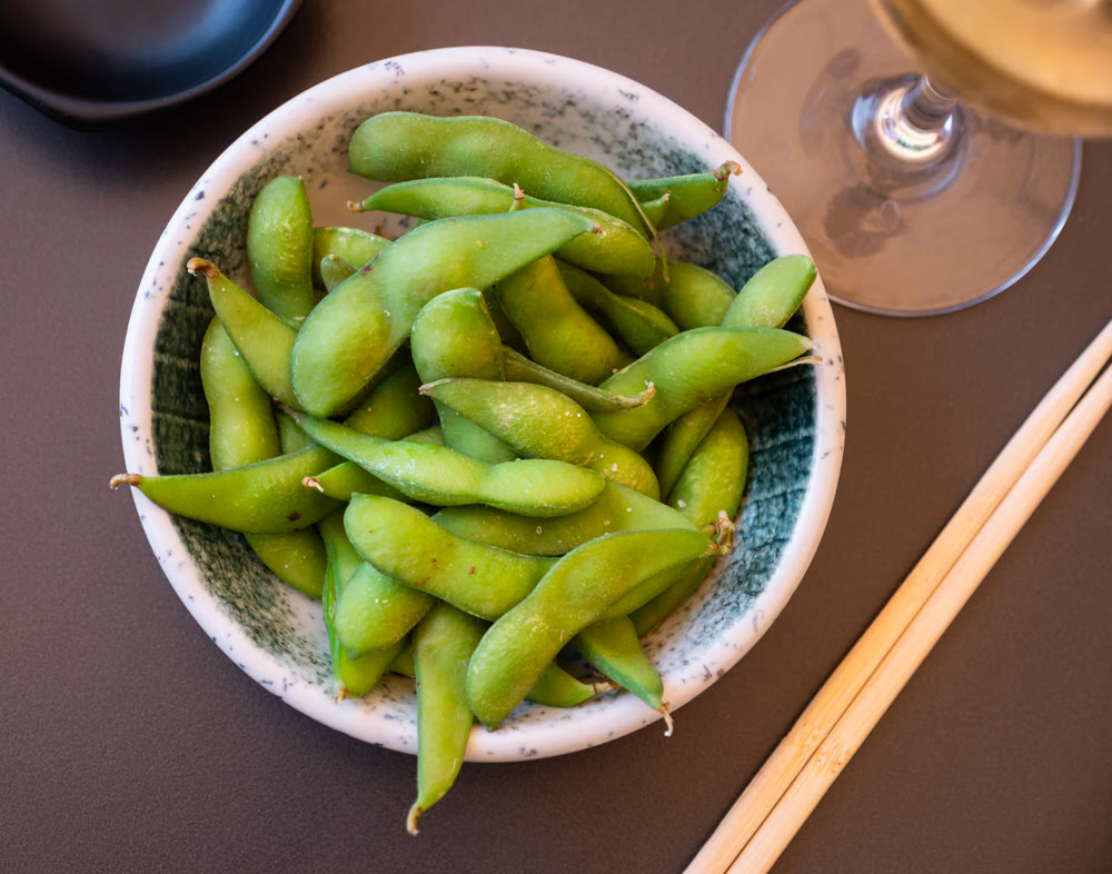 Boiled edamame in a plate top view