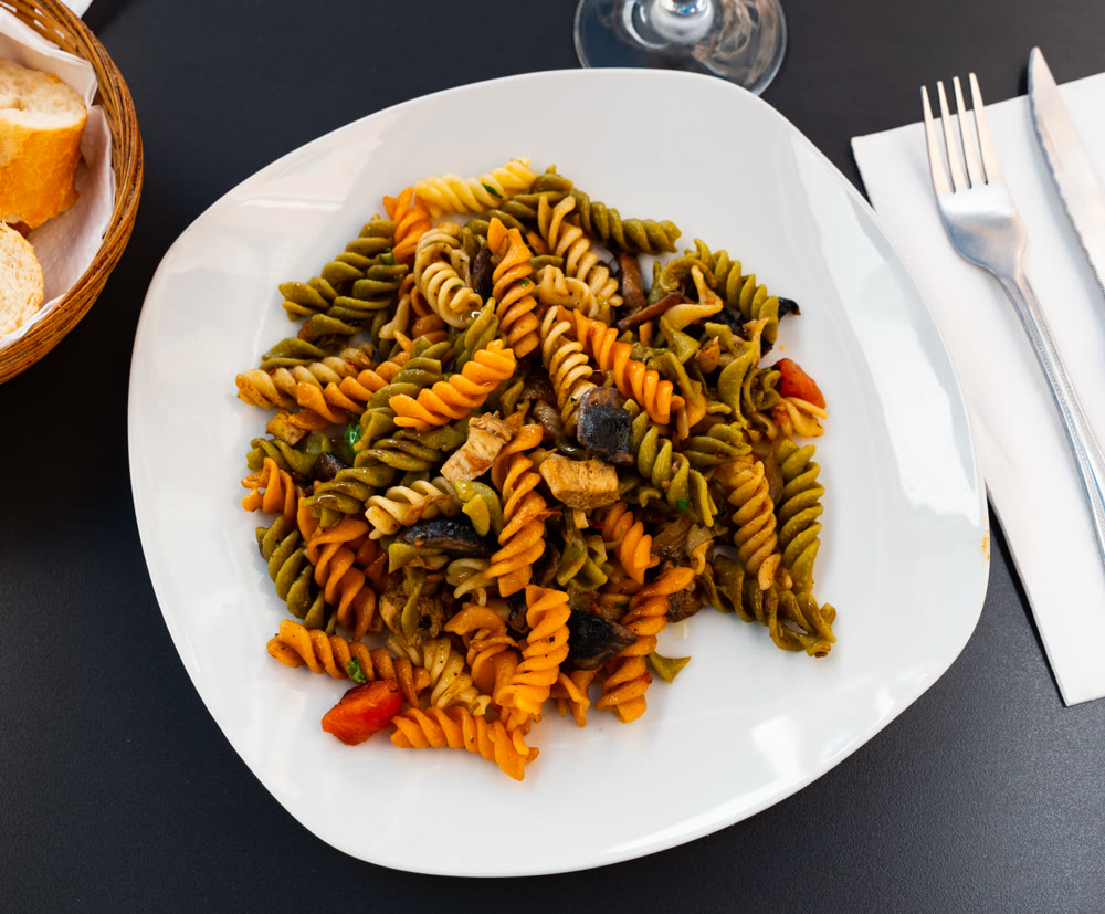 Italian pasta with mushrooms and arugula - a lunch dish