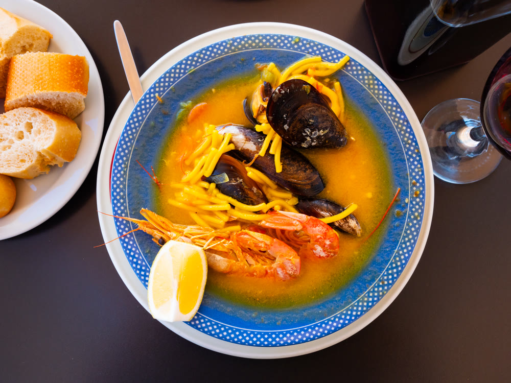 Spicy Mediterranean soup made with seafood and thin noodles.