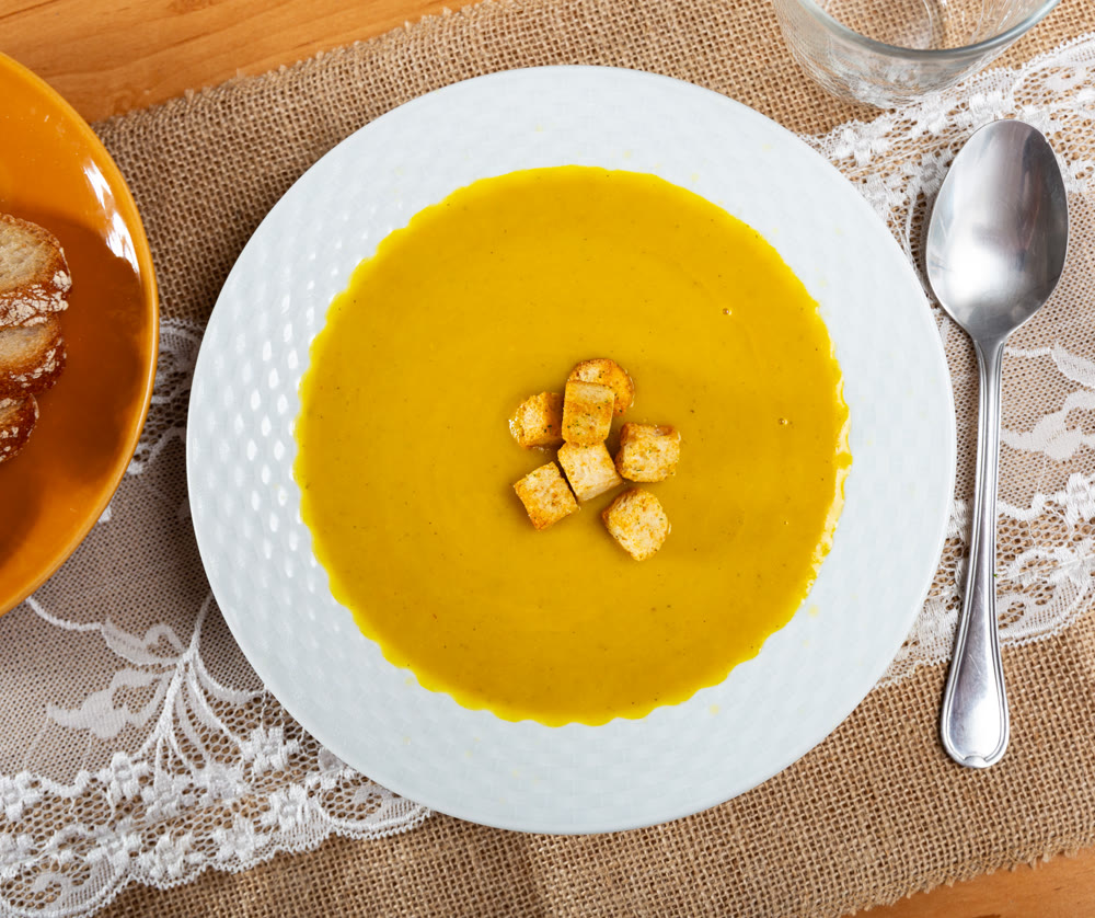 Creamy zucchini soup served with croutons