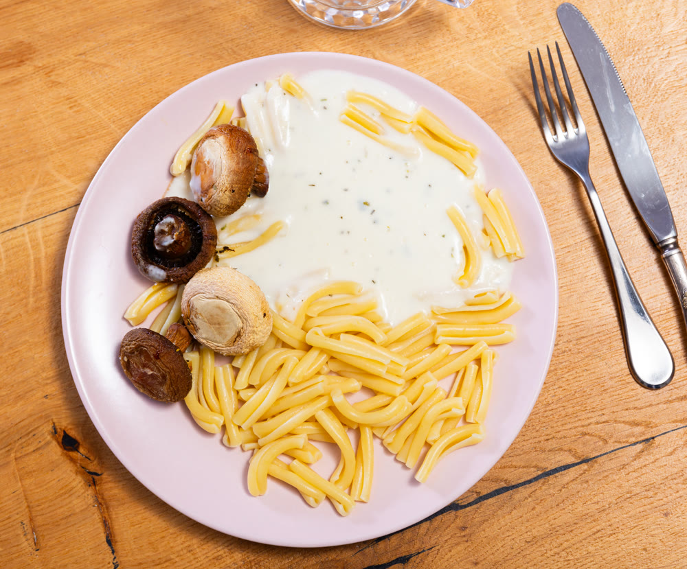 Italian pasta with mushrooms and arugula - a lunch dish