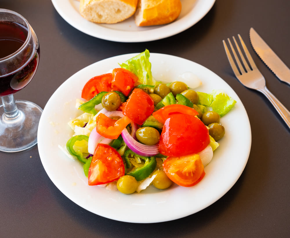 Fresh farm vegetable salad on a plate top view