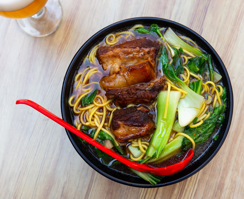 Hot soup with noodles and pork ribs top view