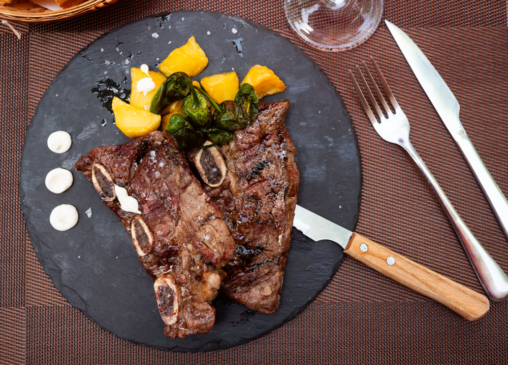 Grilled beef churrasco with roasted potatoes, peppers, and aioli