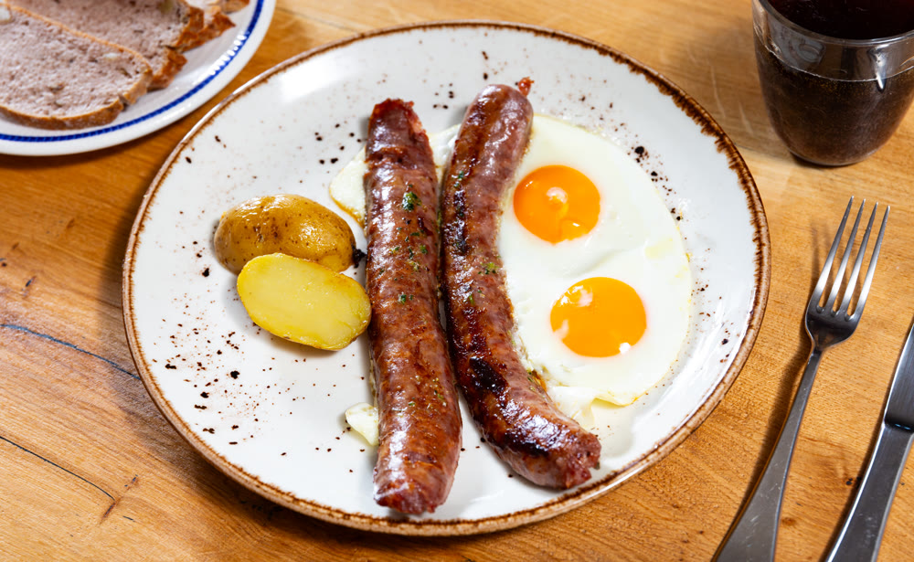 Fried Butifarra sausage with potatoes and eggs
