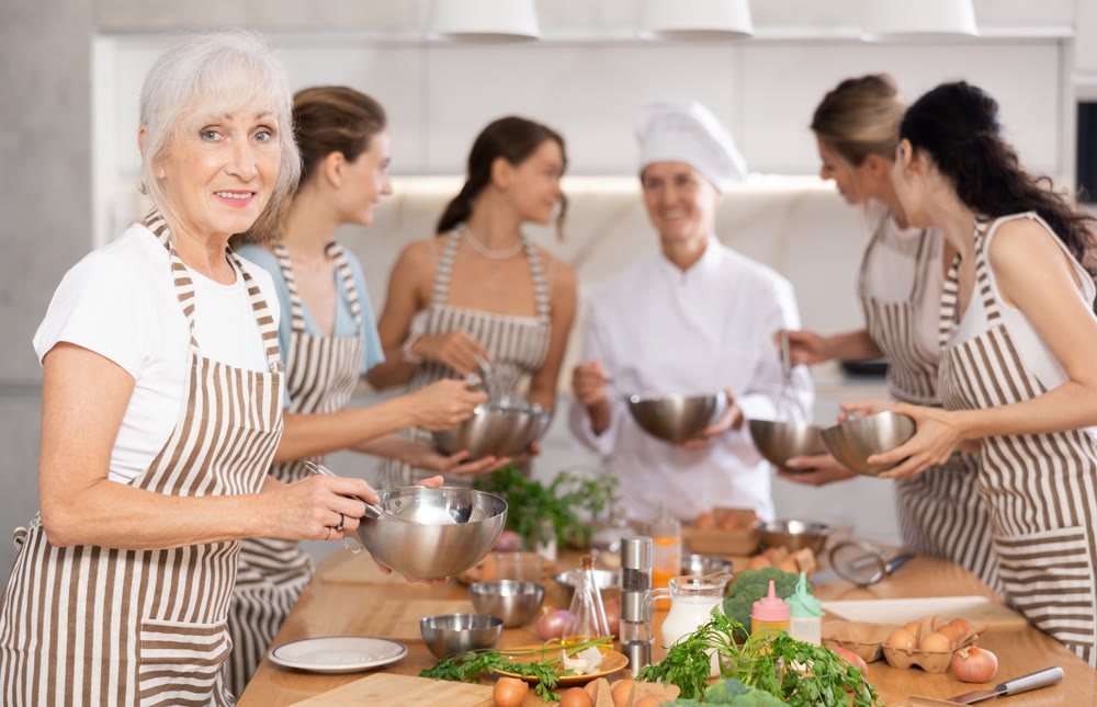 Elderly woman learns to cook at master class