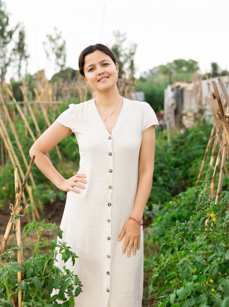 Portrait of a young positive girl in her garden on summer day