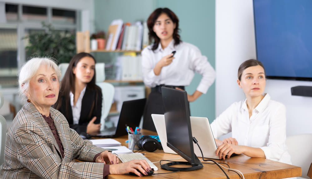 Group of women watching presentation in office