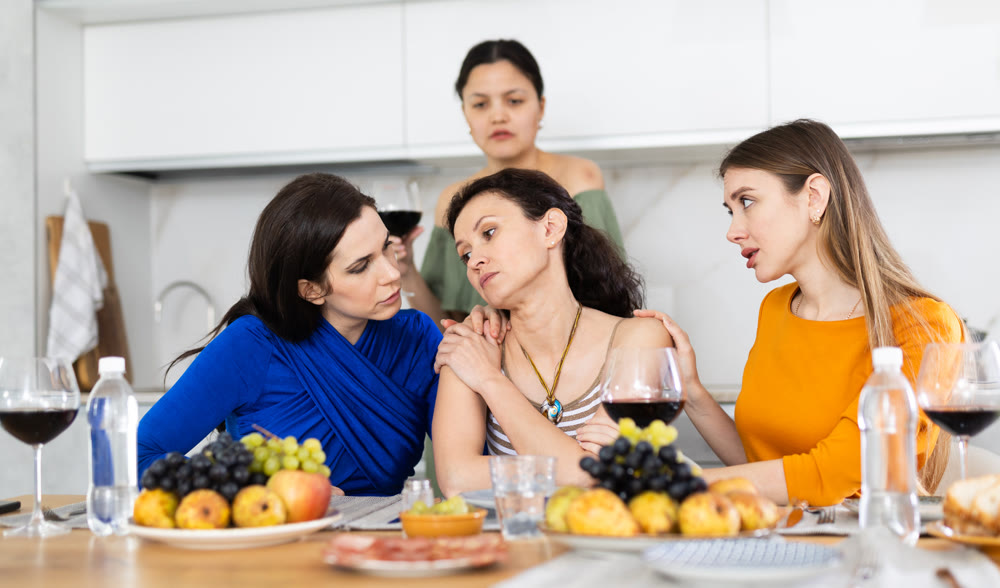 Group of female friends calming adult woman