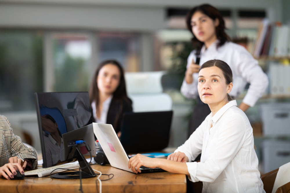 Middle-aged woman watching project presentation in modern office