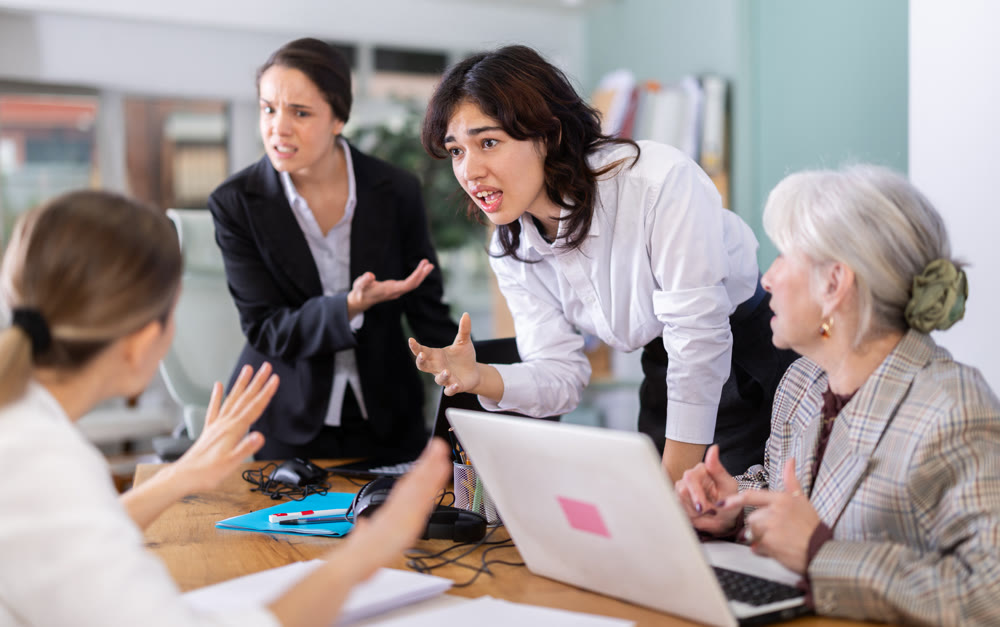Group of female employees in office are shouting at each other
