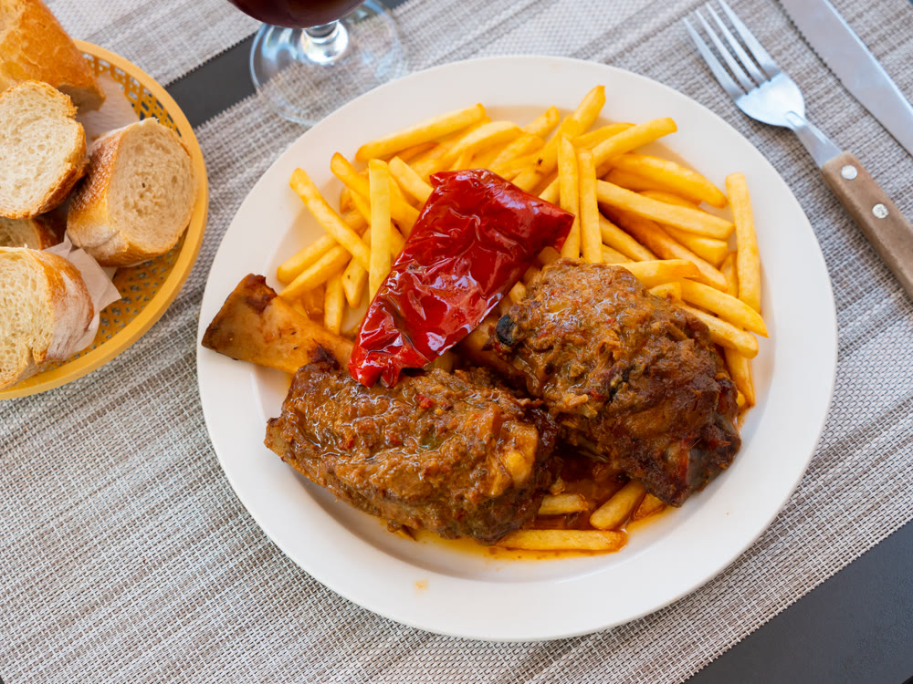 Fried shank with French fries and red pepper